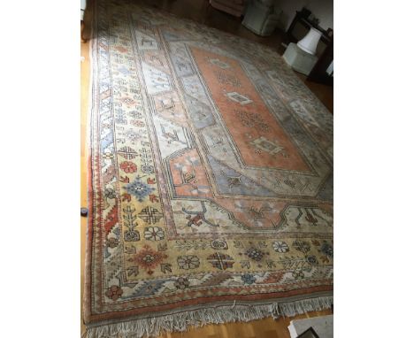 A Persian type red ground carpet, multiple borders centre with repeating foliate forms, 340 x 476 cm 