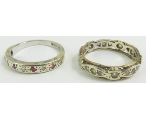 A 9ct white gold ruby and diamond half eternity ring, finger size K 1/2; and a synthetic stone full eternity ring, marked '9c