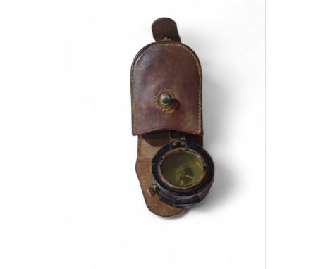 A WWII period marching compass in brown leather case