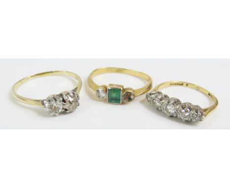 An emerald and diamond three stone ring, marked '18ct plate', finger size K 1/2; and old cut diamond two stone ring, marked '