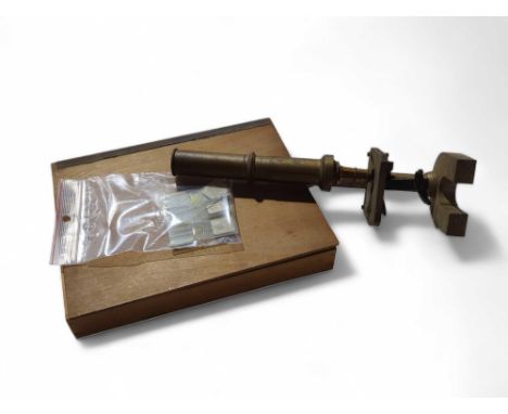 An early 20th Century brass monocular microscope together with a quantity of glass slides of human samples