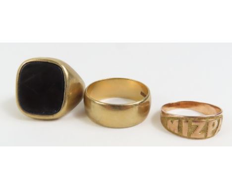 A 9ct gold Mizpah ring, finger size J 1/2, a wide 9ct gold wedding band, finger size R centre and a 9ct gold onyx set signet 