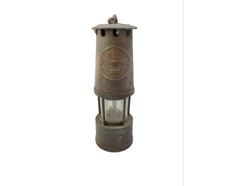 A “Protector” miners lamp with hanging loop, 24cm high