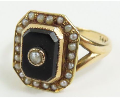 An onyx and split pearl ring, marked '14k', finger size K, 2.6g gross, cased (the pearls untested and unwarranted)