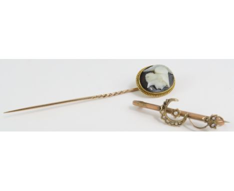 A stick pin with a black and white cameo of Athena/Minerva, the setting tests as 18-22ct gold and the pin tests as 9ct gold; 