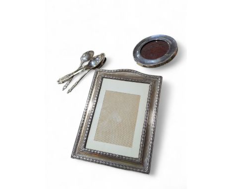 A George V rectangular silver photo frame with oak easel back, aperture 14cms x 9.5cms together with a small circular silver 