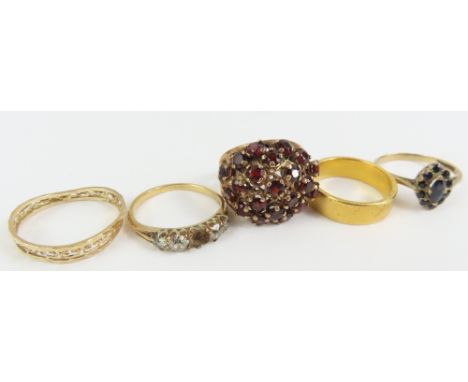 A 9ct gold sapphire cluster ring, finger size O 1/2, a garnet 'bombe' cluster ring, marked '9ct', finger size M centre, 7.3g 