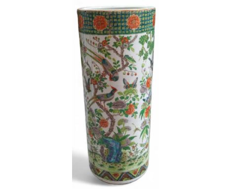 A Cantonese pottery stick stand, the cylindrical stand painted with pheasants flowers and butterflies, 62cms high