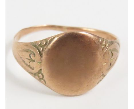 An unmarked signet ring, with patterned shoulders, finger size M, tests as 9ct gold,1.8g gross, cased