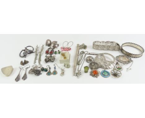 A collection of silver and white metal items to include an 'Ulabrand' brooch, three small enamel buttons and a silver bangle,