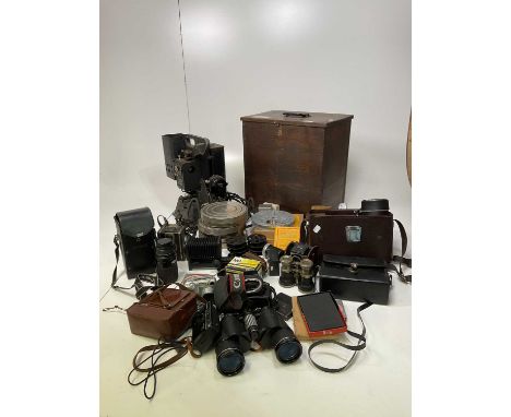 A quantity of cameras, a Kodak film projector, films and spools, binoculars and accessories.