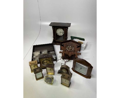 A quantity of assorted clocks and a box of clock parts.