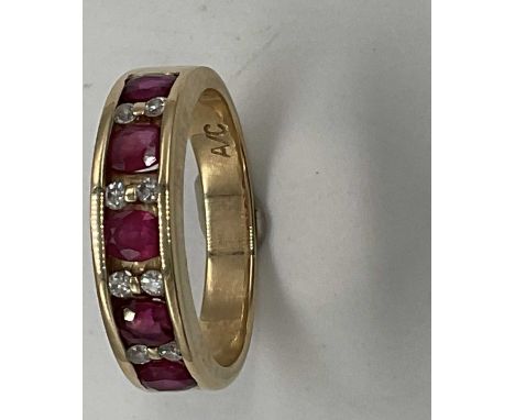 A 14ct yellow gold ruby and diamond half eternity ring, size M1/2, approx. 4.2g. Condition Report: Please note the rubies are