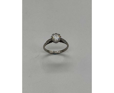 An early 20th century platinum diamond solitaire ring, the raised round brilliant cut diamond weighing approx. 1ct with diamo