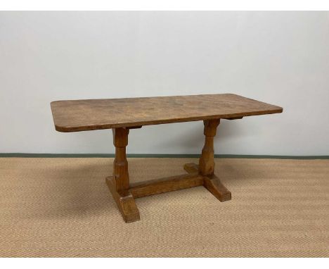 IN THE STYLE OF THE ROBERT THOMPSON 'MOUSEMAN' WORKSHOP; an adzed oak coffee table with rounded rectangular top, length 106cm