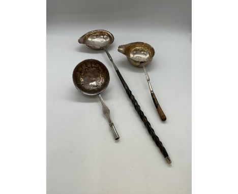 A Georgian toddy ladle with white metal bowl and wrythen twisted baleen handle, length 32cm, a further example with replaced 