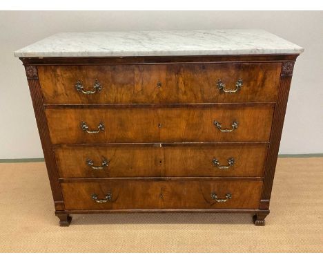 A 19th century figured walnut veneered commode, the veined marble top above four long drawers flanked by fluted uprights and 