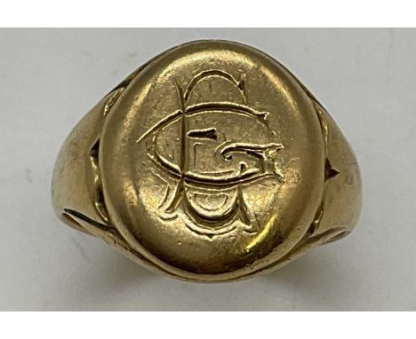 An 18ct yellow gold signet ring engraved with initials to the oval platform, size T, approx. 10.1g. 