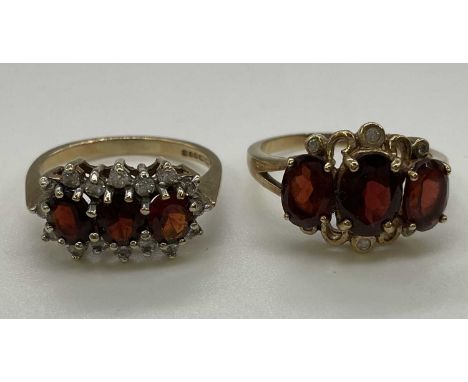 Two 9ct yellow gold garnet set dress rings, combined approx. 6g (2). Large triple stone ring P, small triple stone ring L