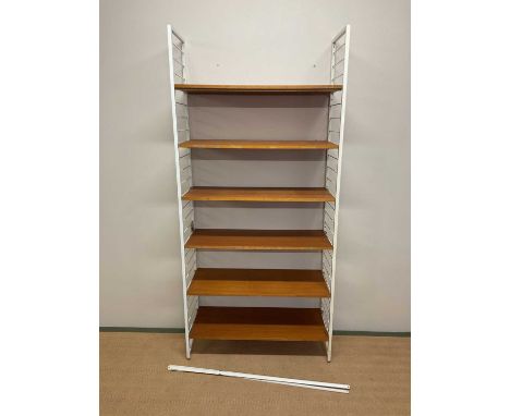 A mid 20th century Ladderax modular shelving system, with six teak shelves, four support bars, twelve shelf support rods and 