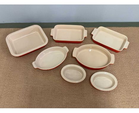 LE CREUSET; seven ceramic ovenware dishes of various sizes.