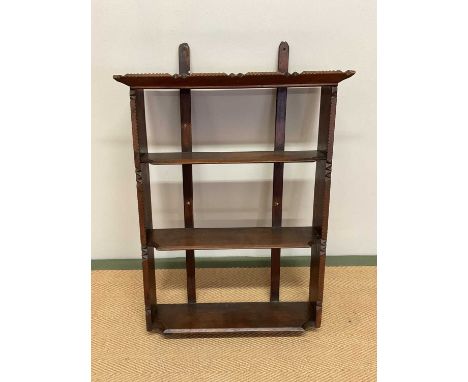 A Tramp Art style three tiered open wall hanging bookcase, width 60cm.