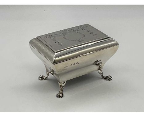 HUKIN &amp; HEATH; a George V hallmarked silver trinket box of bombe rectangular form, the hinged lid engraved with ribbon bo