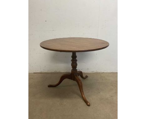 A 19th century mahogany tilt-top tripod table with baluster ring turned central column to three outswept supports, diameter o
