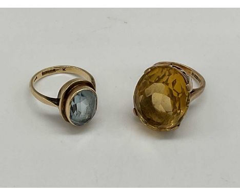 A 9ct yellow gold citrine ring, size G and a further 9ct yellow gold dress ring, size K, combined approx. 12.2g (2).