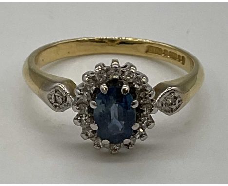 An 18ct yellow gold floral set ring with pale blue central stone, size M1/2, approx. 3g.