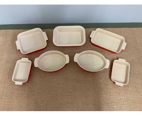 LE CREUSET; seven ceramic ovenware dishes of various sizes.
