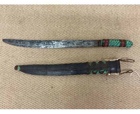 An Indonesian dress sword with leather scabbard, length of blade 45cm.