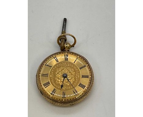 A Victorian 18ct yellow gold key wind open faced fob watch with Roman numerals to the chapter ring, foliate engraved case cen
