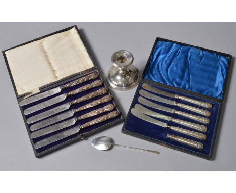 2 cased sets of silver handled knives together with a candlestick and spoon.