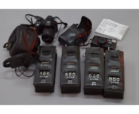 Four large walkie-talkies together with a Nikon TW 200 camera and a Fuji S6500 FD digital camera