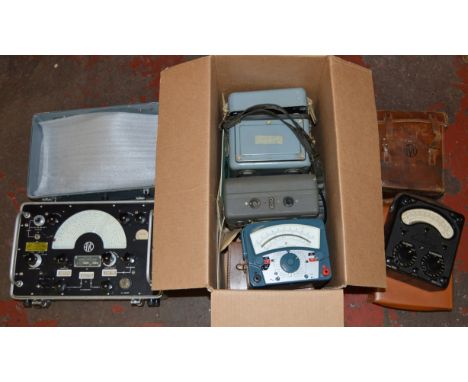 A collection of AVO test meters including Universal AVO meter, some with broad arrow marks, cases and instruction manuals etc