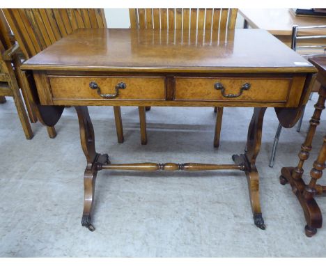 A modern Regency design walnut sofa table with two drawers, raised on opposing lyre shaped supports and sabre legs&nbsp; 30"h