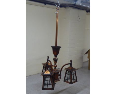 An Arts &amp; Crafts burnished copper pendulum light fitting with three branches and glazed lanterns&nbsp; 35"drop&nbsp; 19"s
