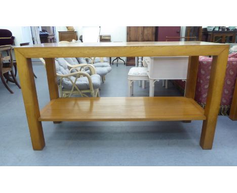 A modern light oak serving table, the top cut with geometric motifs, raised on block legs&nbsp; 36"h&nbsp; 63"w&nbsp; 24"deep