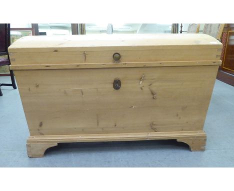 A late Victorian pine dome top trunk with angled sides, raised on bracket feet&nbsp; 31"h&nbsp; 45"w&nbsp; 25"deep 