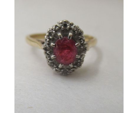 An 18ct gold cluster ring, set with a central ruby, surrounded by diamonds&nbsp; 