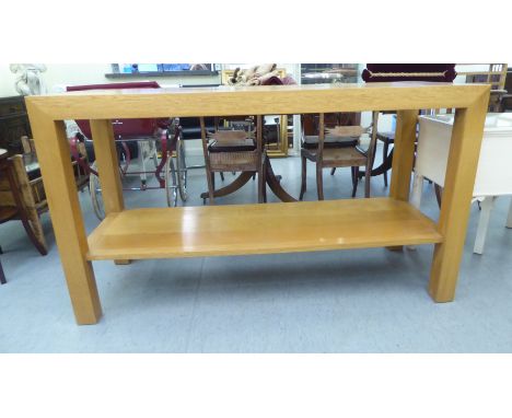 A modern light oak serving table, the top cut with geometric motif, raised on block legs&nbsp; 36"h&nbsp; 63"w&nbsp; 24"deep 