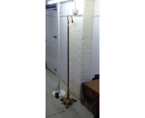 An early 20thC style brass standard lamp, the angled bulb holder in a straight column and triform base&nbsp; 64"h; and a mode