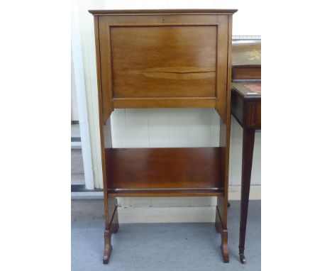 An Edwardian satinwood inlaid mahogany students desk, the rising top and fall front enclosing a fitted interior, over a book 