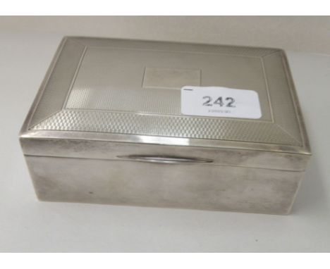 A silver cigarette box with an engine turned hinged lid&nbsp; indistinct Birmingham mark&nbsp; 2"h&nbsp; 5"w 