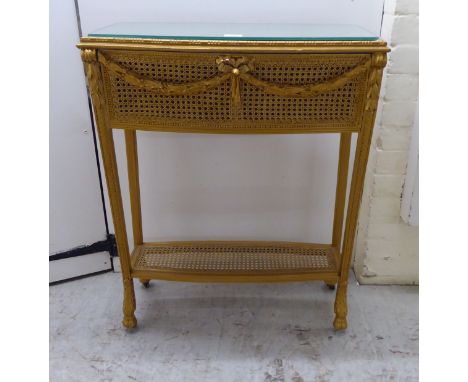 An early 20thC gilded wood console table with a mirrored top and caned sides, raised on carved legs&nbsp; 32"h&nbsp; 26"w&nbs
