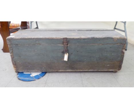 An early 20thC painted pine trunk with iron clasps&nbsp; 14"h&nbsp; 40"w&nbsp; 19"deep 