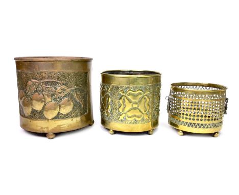ARTS &amp; CRAFTS BRASS PLANTER, with stylised floral motif decoration, on four ball feet, 20cm diameter, along with two earl