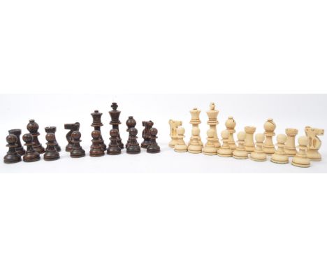 A collection of vintage 20th century turned wood chess pieces with lacquered and faux bone effect. Total thirty pieces. Large