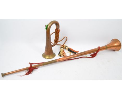 A pair of 20th century copper horns to include a coaching / post horn alongside a copper and brass hunting bugle, each having